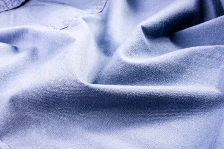clothing items washed cotton fabric texture with seams, clasps, buttons and rivets, macro, close-upの写真素材