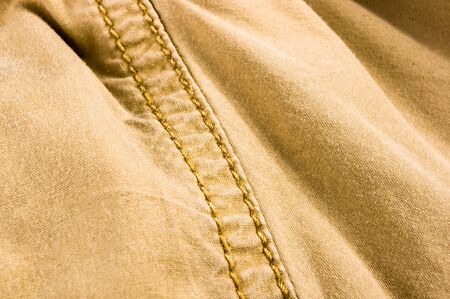 clothing items washed cotton fabric texture with seams, clasps, buttons and rivets, macro, close-upの写真素材