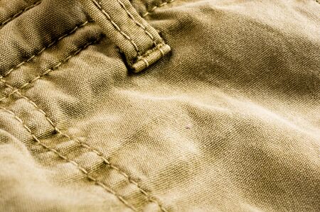 clothing items washed cotton fabric texture with seams, clasps, buttons and rivets, macro, close-upの写真素材