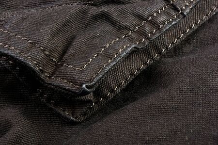 clothing items washed cotton fabric texture with seams, clasps, buttons and rivets, macro, close-upの写真素材