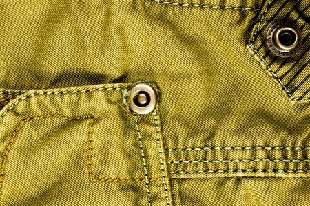 clothing items washed cotton fabric texture with seams, clasps, buttons and rivets, macro, close-upの写真素材
