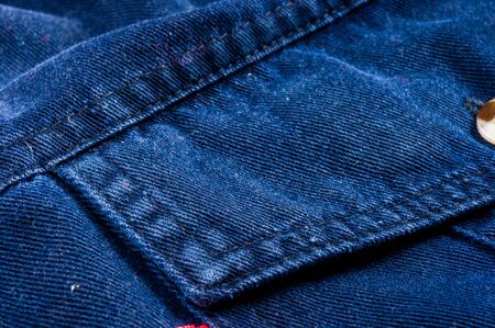 clothing items washed cotton fabric texture with seams, clasps, buttons and rivets, macro, close-upの写真素材