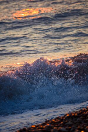 Summer sea sunset, the sun, waves and clouds, beautiful dramatic lightingの写真素材