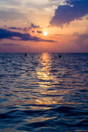 Summer sea sunset, the sun, waves and clouds, beautiful dramatic lightingの写真素材