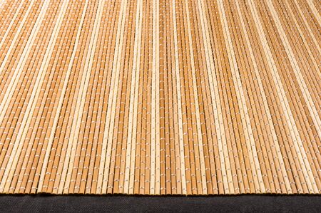 brown bamboo Mat - stand food, close-up, macro, black backgroundの写真素材