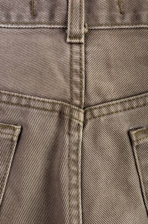 clothing items washed cotton fabric texture with seams, clasps, buttons and rivets, macro, close-upの写真素材