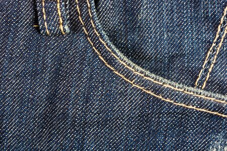clothing items blue washed faded jeans cotton fabric texture with seams, clasps, buttons and rivets, macroの写真素材