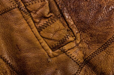 Old vintage genuine soft brown leather texture background, top layer with pores and scratches, macroの写真素材
