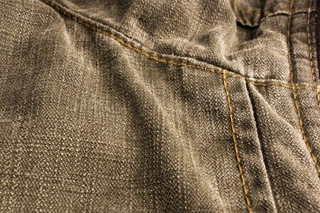 clothing items washed cotton fabric texture with seams, clasps, buttons and rivets, macro, close-upの写真素材