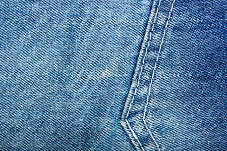 clothing items blue washed faded jeans cotton fabric texture with seams, clasps, buttons and rivets, macroの写真素材