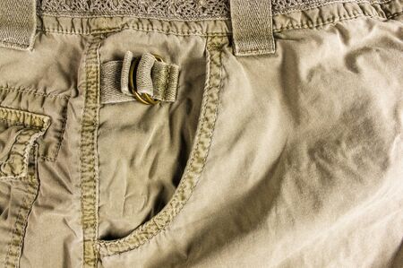 clothing items washed cotton fabric texture with seams, clasps, buttons and rivets, macro, close-upの写真素材