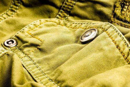 clothing items washed cotton fabric texture with seams, clasps, buttons and rivets, macro, close-upの写真素材