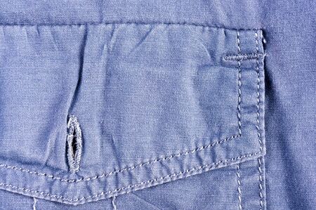 clothing items washed cotton fabric texture with seams, clasps, buttons and rivets, macro, close-upの写真素材
