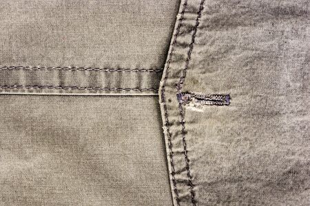 clothing items washed cotton fabric texture with seams, clasps, buttons and rivets, macro, close-upの写真素材