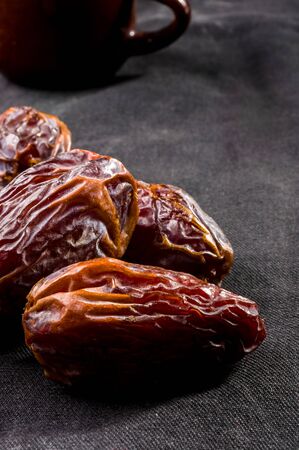 Big luxury dried date fruit on the dark surface, kurma ramadan kareem concept.の写真素材