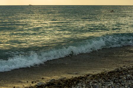 Summer sea sunset, the sun, waves and clouds, beautiful dramatic lightingの写真素材