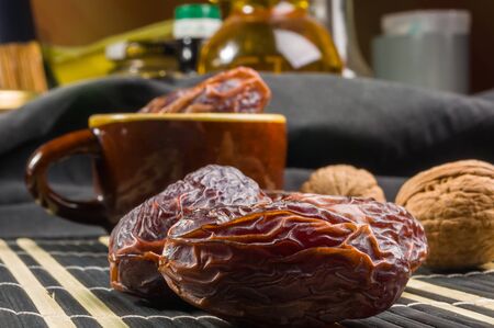 Big luxury dried date fruit on the bamboo mat, kurma ramadan kareem concept.の写真素材