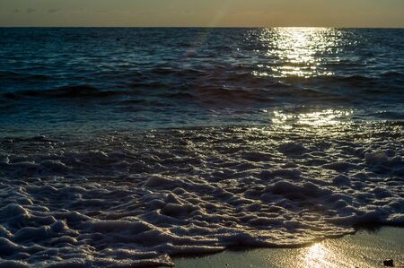 Summer sea sunset, the sun, waves and clouds, beautiful dramatic lightingの写真素材