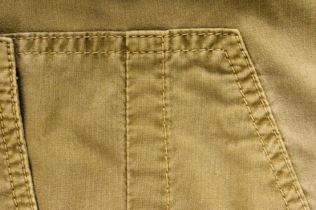 clothing items washed cotton fabric texture with seams, clasps, buttons and rivets, macro, close-upの写真素材