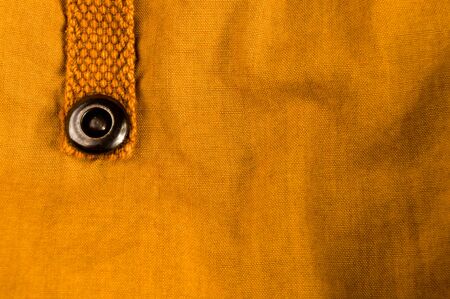 clothing items washed cotton fabric texture with seams, clasps, buttons and rivets, macro, close-upの写真素材