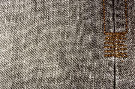 clothing items washed cotton fabric texture with seams, clasps, buttons and rivets, macro, close-upの写真素材