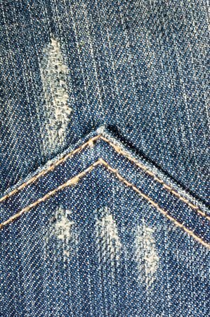 clothing items blue washed faded jeans cotton fabric texture with seams, clasps, buttons and rivets, macroの写真素材