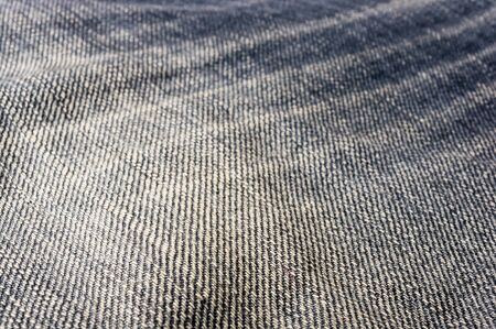 clothing items blue washed faded jeans cotton fabric texture with seams, clasps, buttons and rivets, macroの写真素材