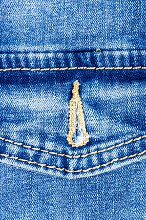 clothing items blue washed faded jeans cotton fabric texture with seams, clasps, buttons and rivets, macroの写真素材