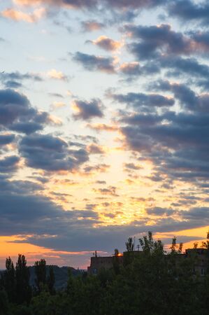 Landscape with dramatic light - beautiful golden sunset with saturated sky and clouds, peaceful nature serene background.の写真素材