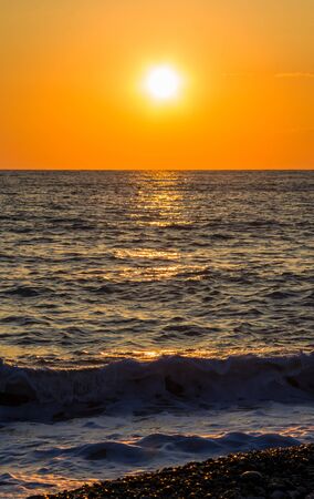 Summer sea sunset, the sun, waves and clouds, beautiful dramatic lightingの写真素材