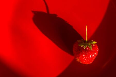fresh ripe berries strawberries on red ceramic plate, macroの写真素材