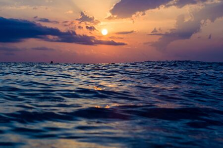 Summer sea sunset, the sun, waves and clouds, beautiful dramatic lightingの写真素材