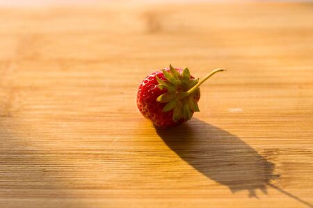 fresh ripe berries strawberries on bamboo board, macroの写真素材