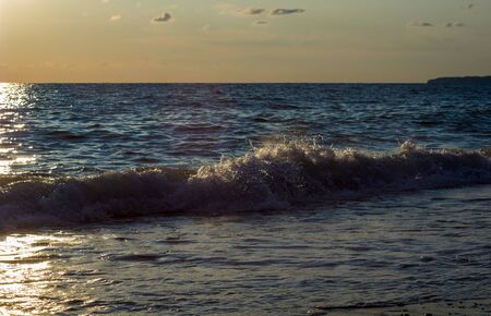 Summer sea sunset, the sun, waves and clouds, beautiful dramatic lightingの写真素材