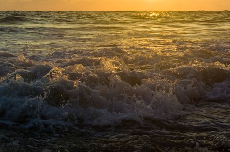 Summer sea sunset, the sun, waves and clouds, beautiful dramatic lightingの写真素材
