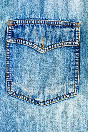 clothing items blue washed faded jeans cotton fabric texture with seams, clasps, buttons and rivets, macroの写真素材