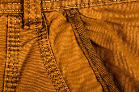 clothing items washed cotton fabric texture with seams, clasps, buttons and rivets, macro, close-upの写真素材