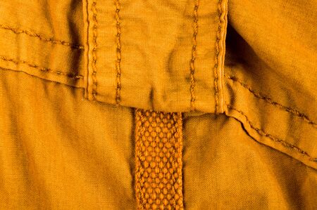 clothing items washed cotton fabric texture with seams, clasps, buttons and rivets, macro, close-upの写真素材