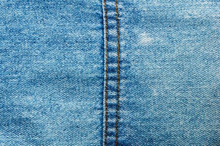 clothing items blue washed faded jeans cotton fabric texture with seams, clasps, buttons and rivets, macroの写真素材