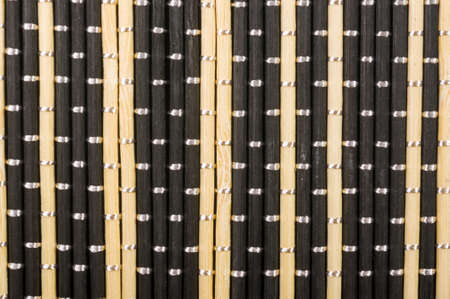 brown bamboo Mat - stand food, close-up, macro, black backgroundの写真素材