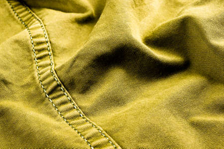 clothing items washed cotton fabric texture with seams, clasps, buttons and rivets, macro, close-up