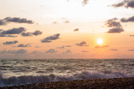 Summer sea sunset, the sun, waves and clouds, beautiful dramatic lightingの写真素材