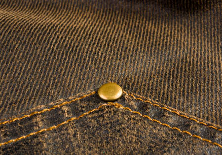 clothing items washed cotton fabric texture with seams, clasps, buttons and rivets, macro, close-up