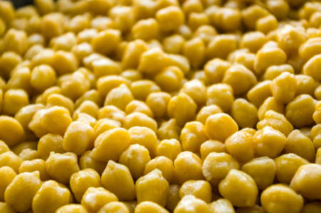 Cooking chickpeas with spices in a pan, close upの写真素材