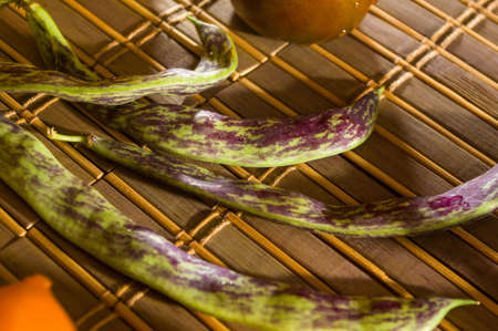 Still life - asparagus beans, purple Basil, yellow and chocolate tomatoes on bamboo Matの写真素材