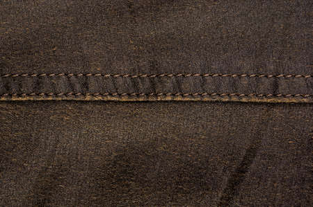 clothing items washed cotton fabric texture with seams, clasps, buttons and rivets, macro, close-up