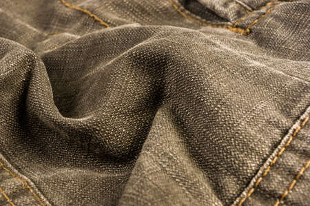 clothing items washed cotton fabric texture with seams, clasps, buttons and rivets, macro, close-up