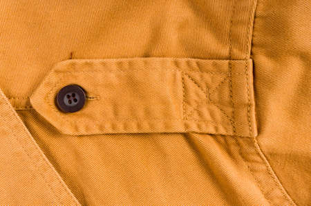 clothing items washed cotton fabric texture with seams, clasps, buttons and rivets, macro, close-up