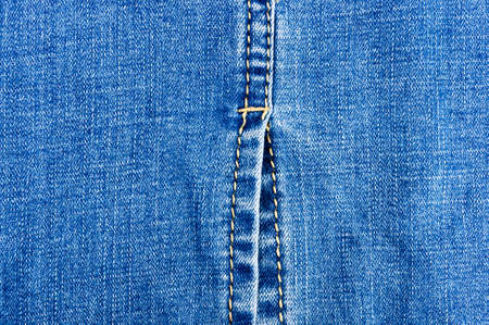 clothing items blue washed faded jeans cotton fabric texture with seams, clasps, buttons and rivets,...