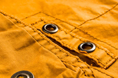 clothing items washed cotton fabric texture with seams, clasps, buttons and rivets, macro, close-upの写真素材